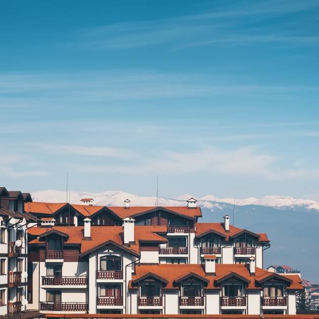 Mountain ski resort - nature and sky background. Balkans mountains snow peaks, houses and hotels, winter.